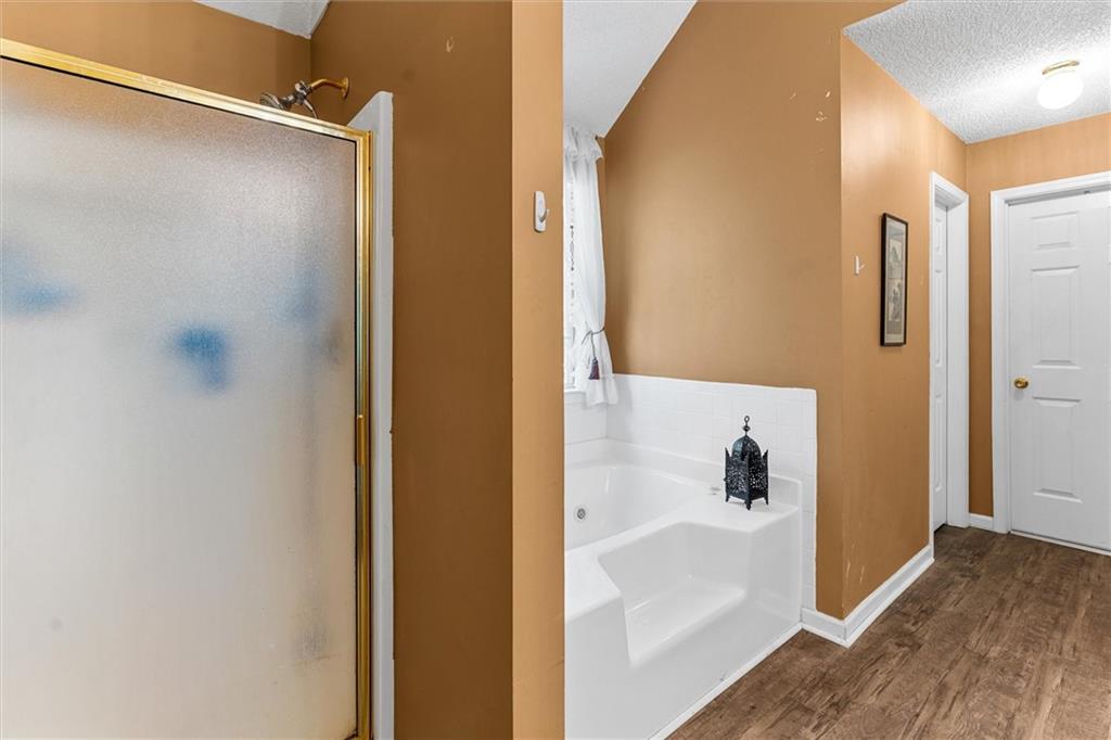 3234 Mineral Ridge Lane Stone Mountain, GA 30087 - Photo 28 of 55 a bathroom with a shower and a bath tub