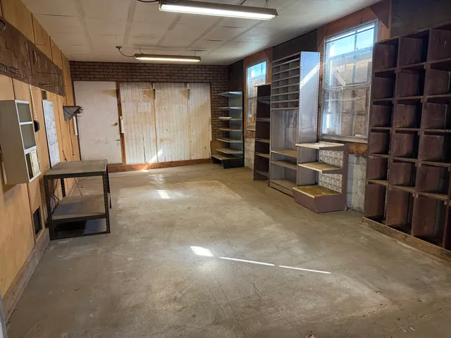 a view of an empty room with a staircase