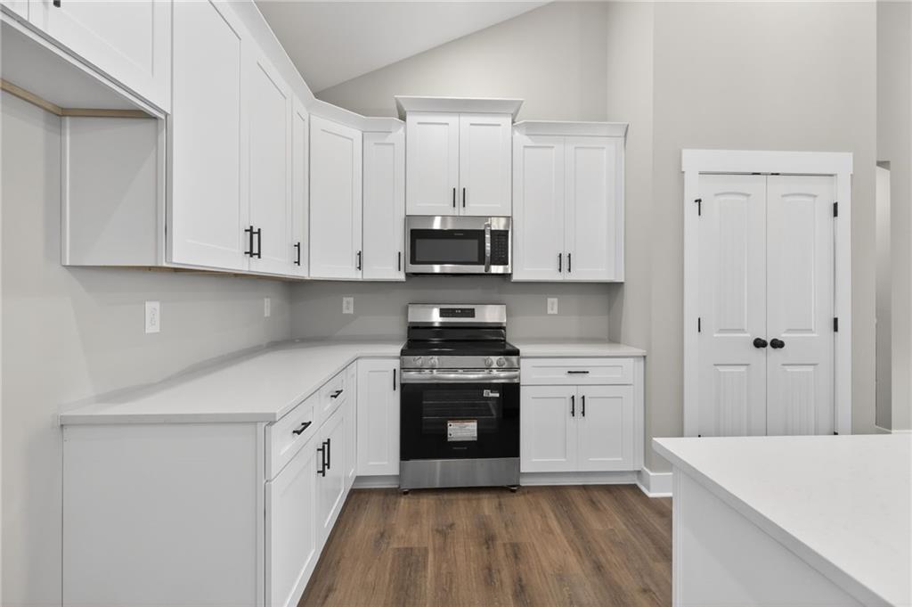 423 Relay Road Silver Creek, GA 30173 - Photo 19 of 48 a kitchen with stainless steel appliances granite countertop a stove and white cabinets