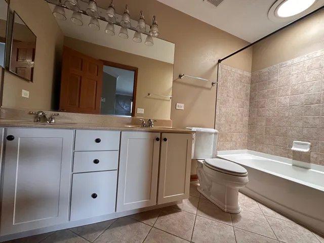 a bathroom with a granite countertop sink mirror and toilet