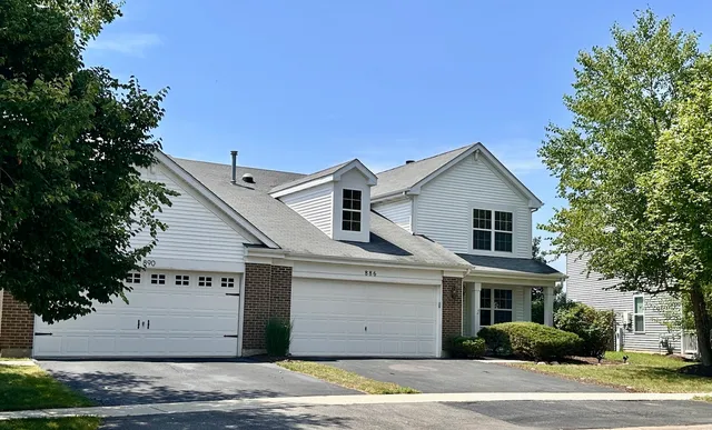 a view of a house with a yard and garage