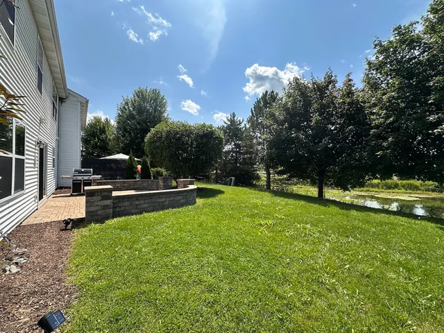 a swimming pool with outdoor seating and yard