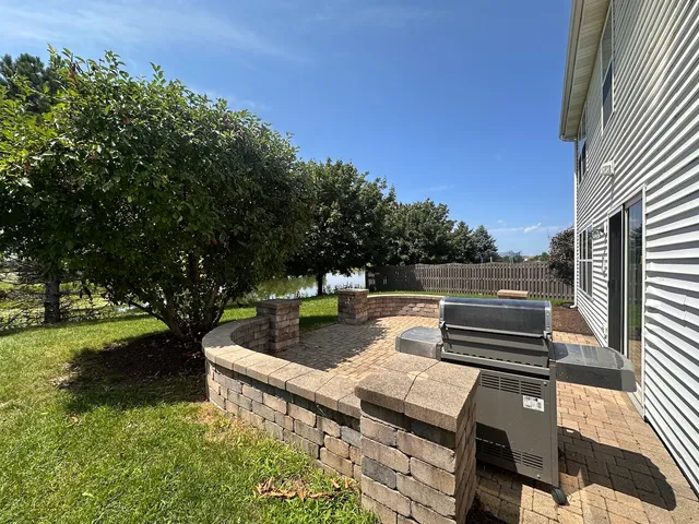a view of a patio with couches chairs and a fire pit with an outdoor space