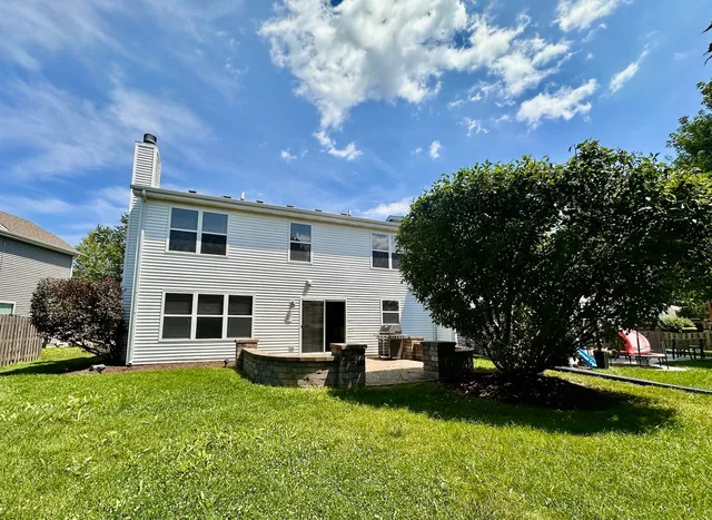 a view of a house with a yard porch and sitting area