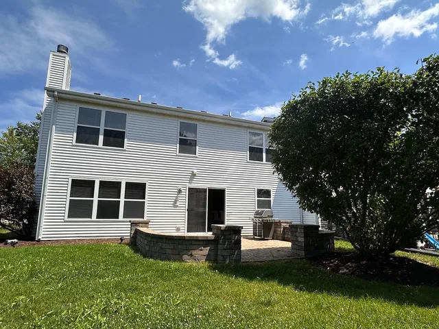 a front view of a house with yard and green space