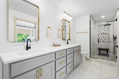 a bathroom with a double vanity sink mirror and bathtub