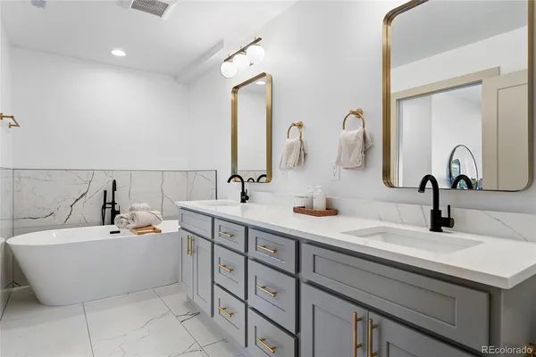 a bathroom with a double vanity sink and a mirror