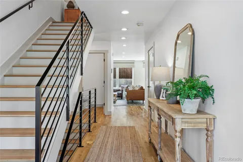 a view of entryway and hall with wooden floor