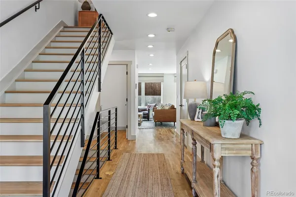a view of entryway and hall with wooden floor