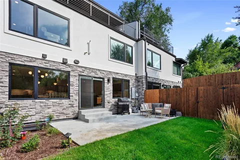a view of a house with backyard and porch