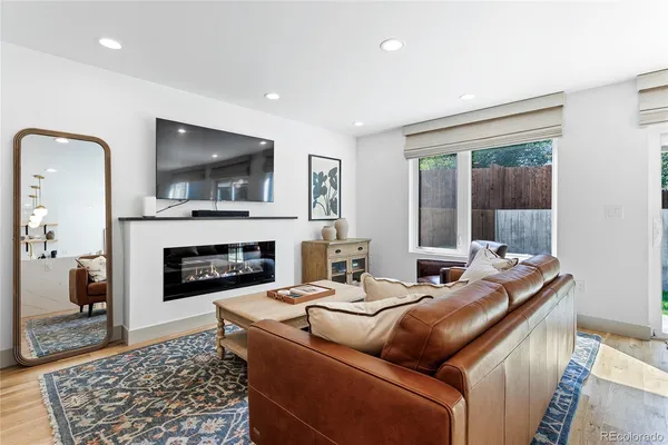 a living room with furniture fireplace and flat screen tv