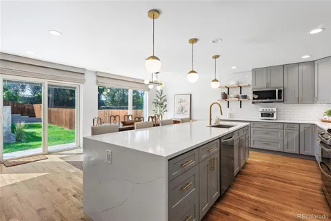 a kitchen with kitchen island a sink appliances and cabinets