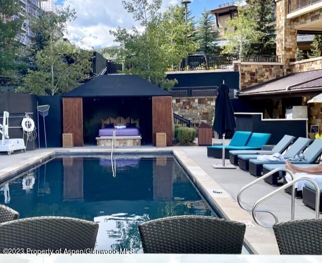 130 Wood Road, Unit 507 Snowmass Village, CO 81615 - Photo 12 of 27 a view of a chairs and table on the roof deck