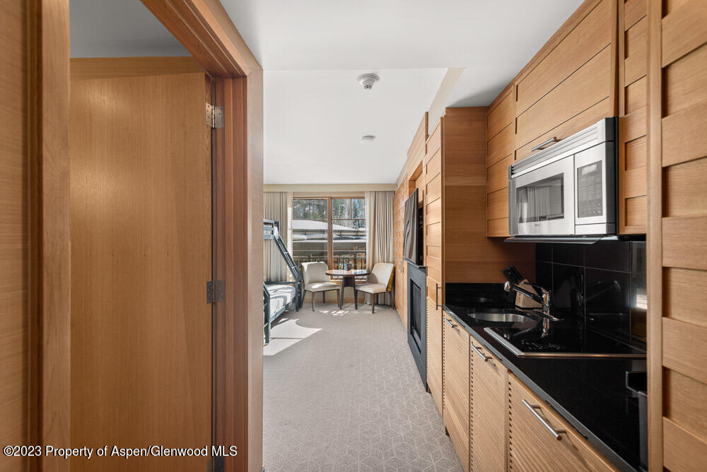 130 Wood Road, Unit 507 Snowmass Village, CO 81615 - Photo 6 of 27 a kitchen with a refrigerator and a stove
