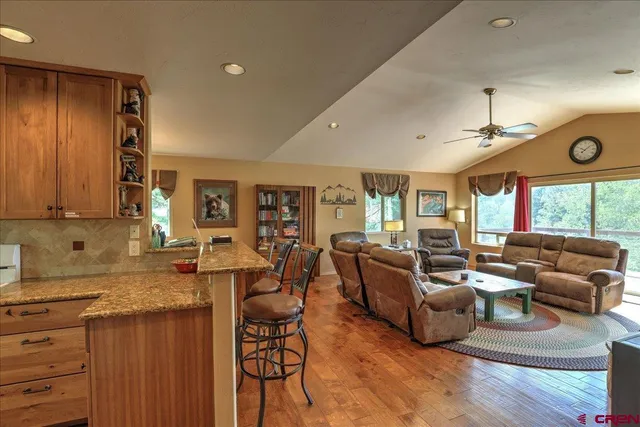 a living room with furniture a fireplace and a large window