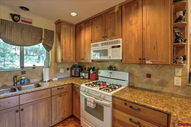 a kitchen with appliances cabinets and a window
