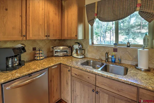 a kitchen with a sink a window cabinets and a counter space