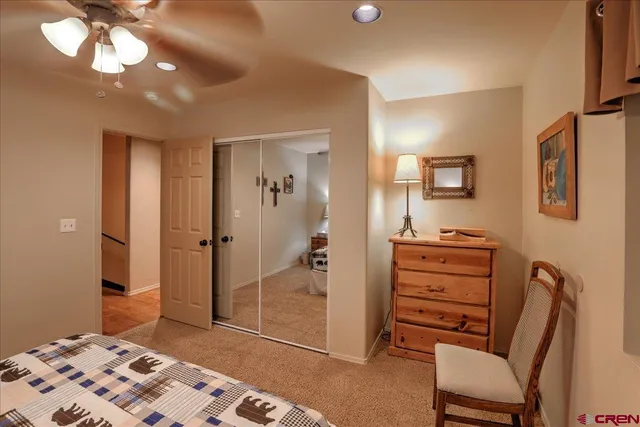 a bedroom with a bed and a chair in it