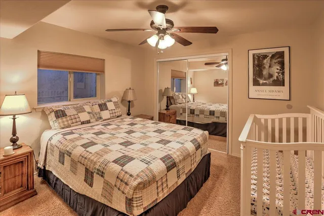 a bedroom with bed and a chandelier