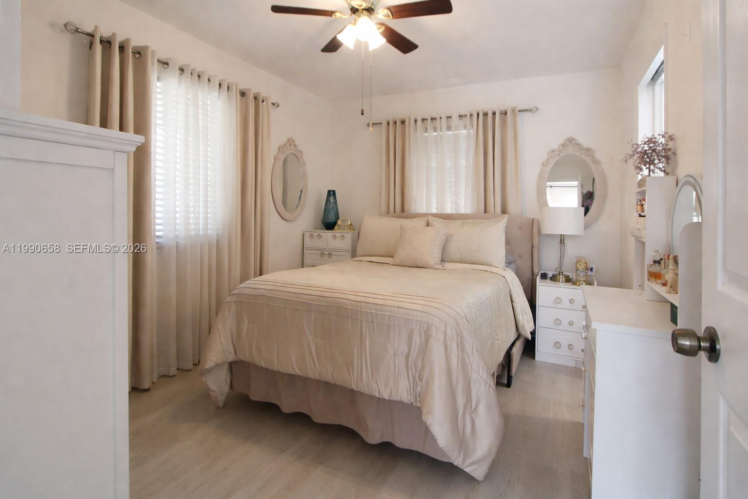 2314 Southwest 60th Avenue Miami, FL 33155 - Photo 12 of 45 a spacious bedroom with a bed and a chandelier