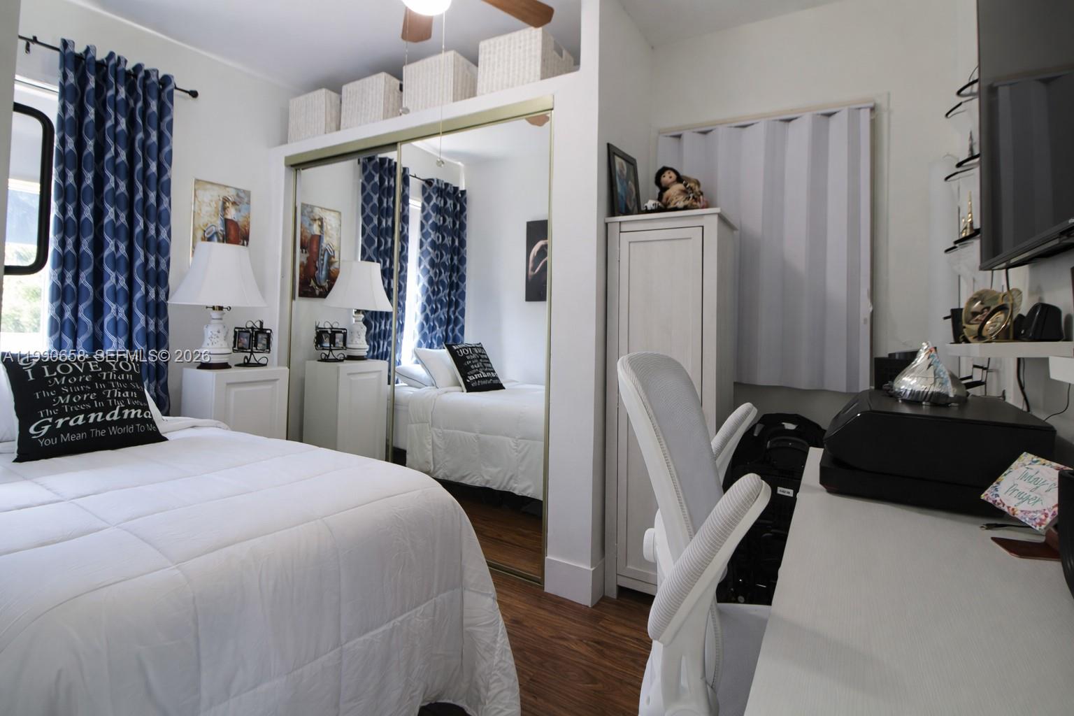 2314 Southwest 60th Avenue Miami, FL 33155 - Photo 15 of 45 a bedroom with a bed furniture and a flat tv screen