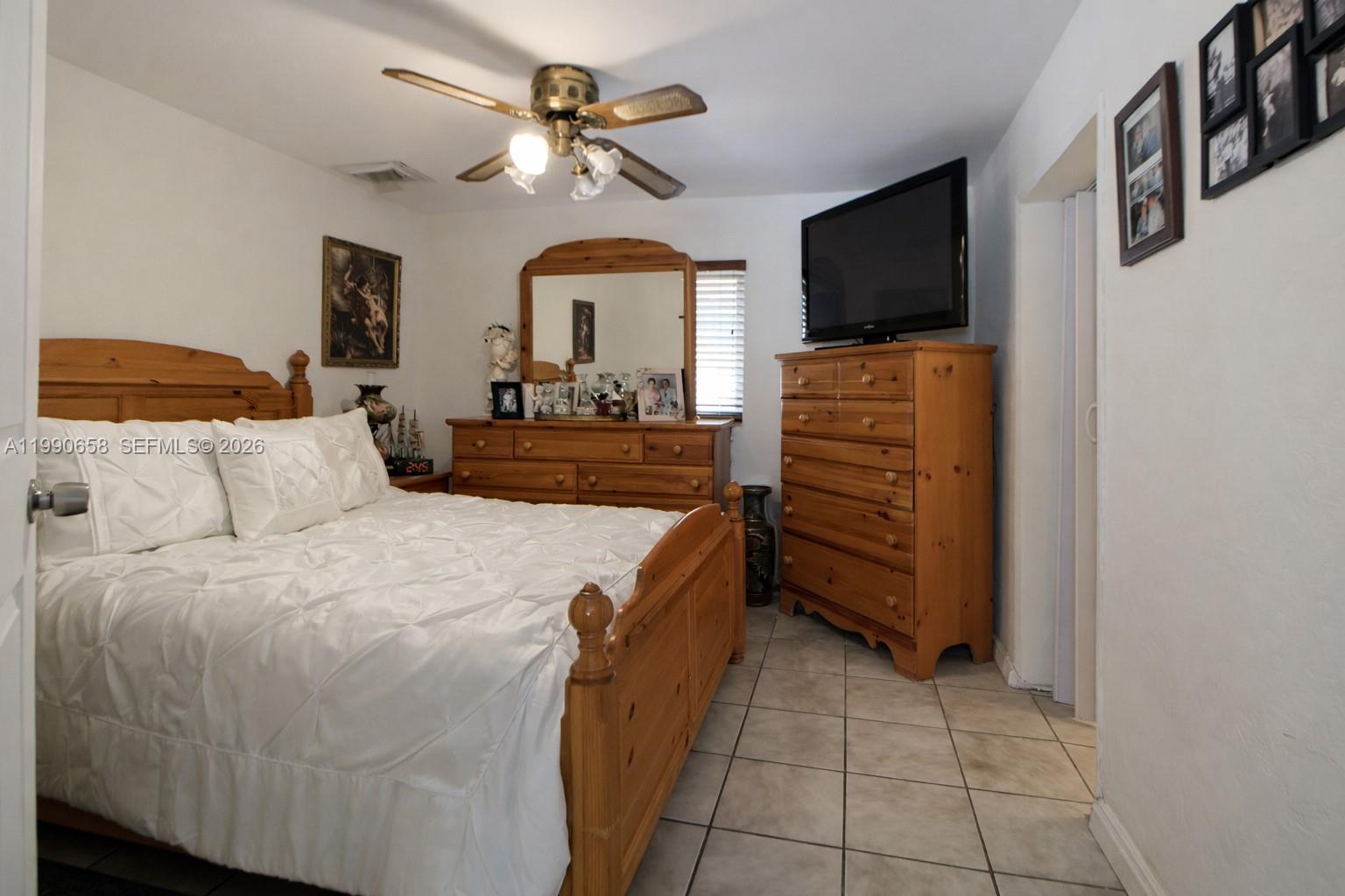 2314 Southwest 60th Avenue Miami, FL 33155 - Photo 16 of 45 a bed room with a bed and a television