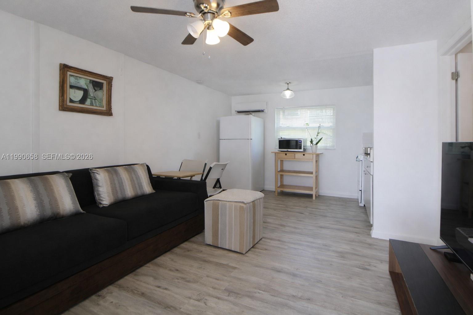 2314 Southwest 60th Avenue Miami, FL 33155 - Photo 21 of 45 a living room with furniture and a flat screen tv