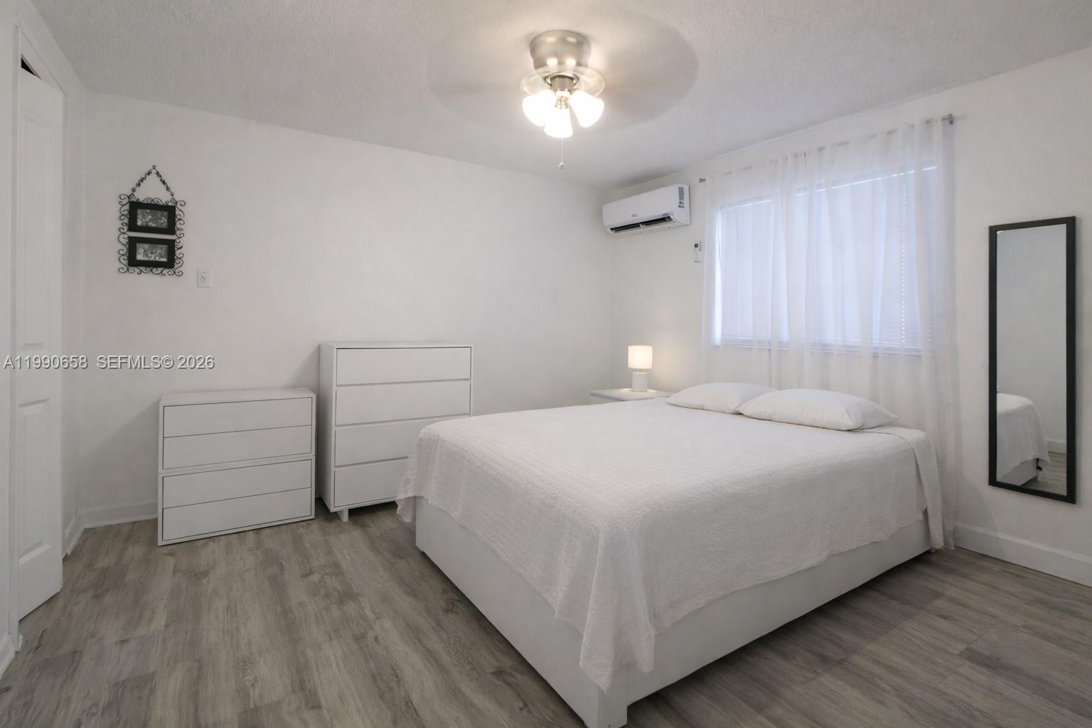 2314 Southwest 60th Avenue Miami, FL 33155 - Photo 23 of 45 a bedroom with a bed and a chandelier