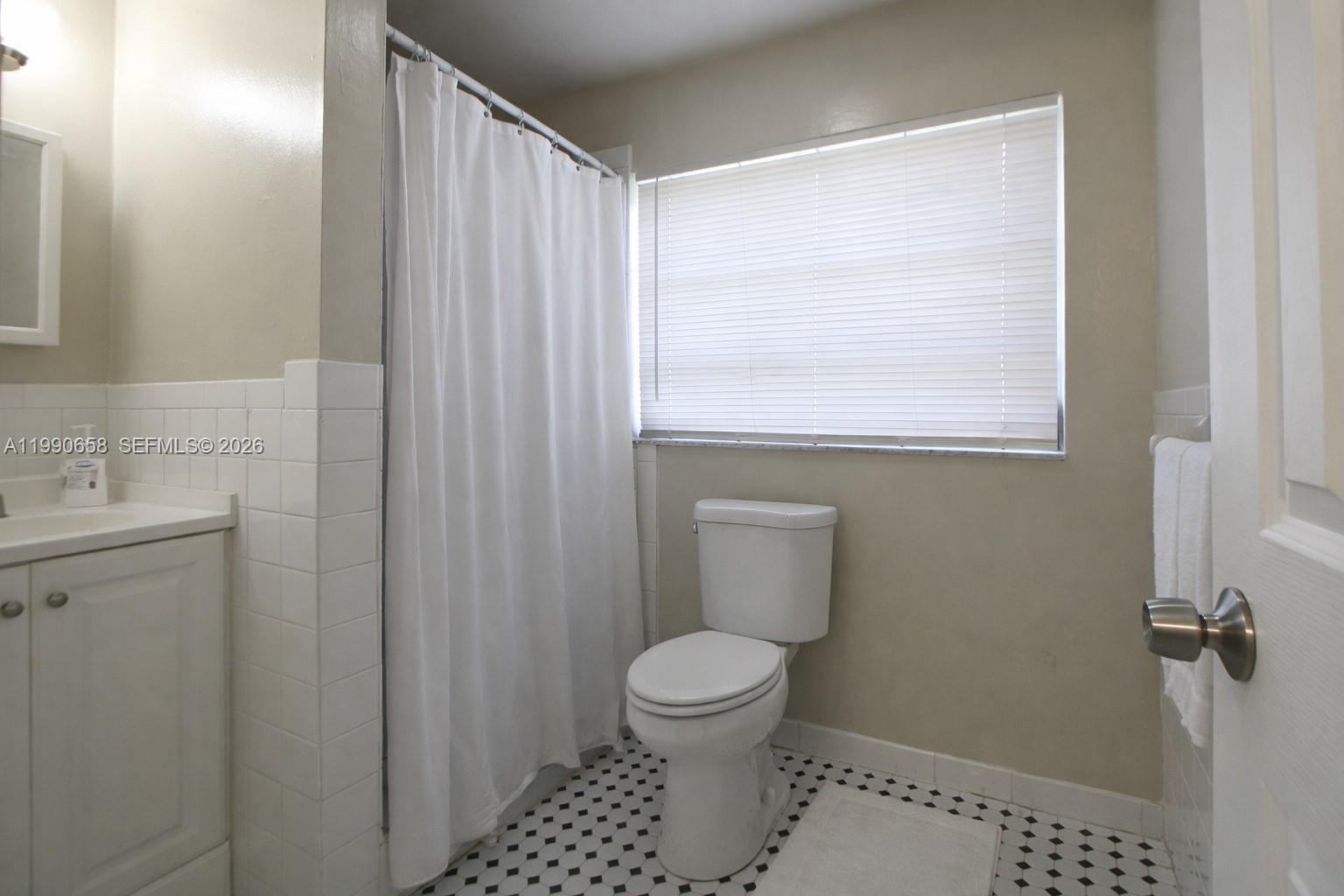 2314 Southwest 60th Avenue Miami, FL 33155 - Photo 24 of 45 a bathroom with a toilet a sink and a window