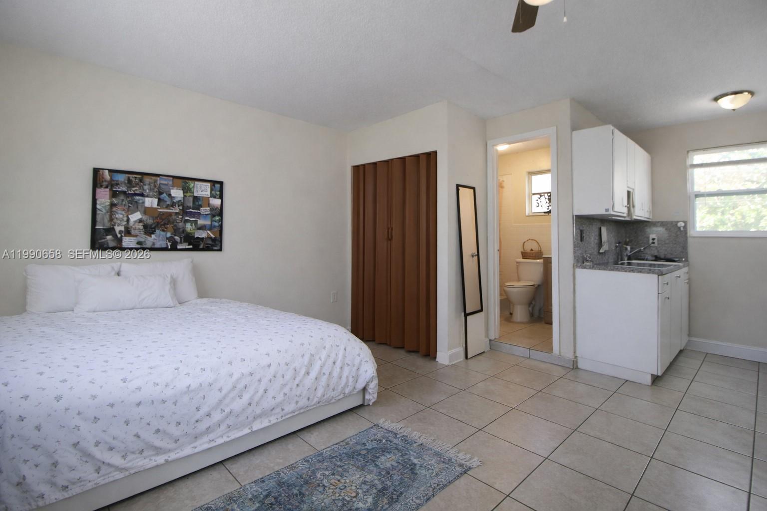 2314 Southwest 60th Avenue Miami, FL 33155 - Photo 25 of 45 a bedroom with a bed and a refrigerator