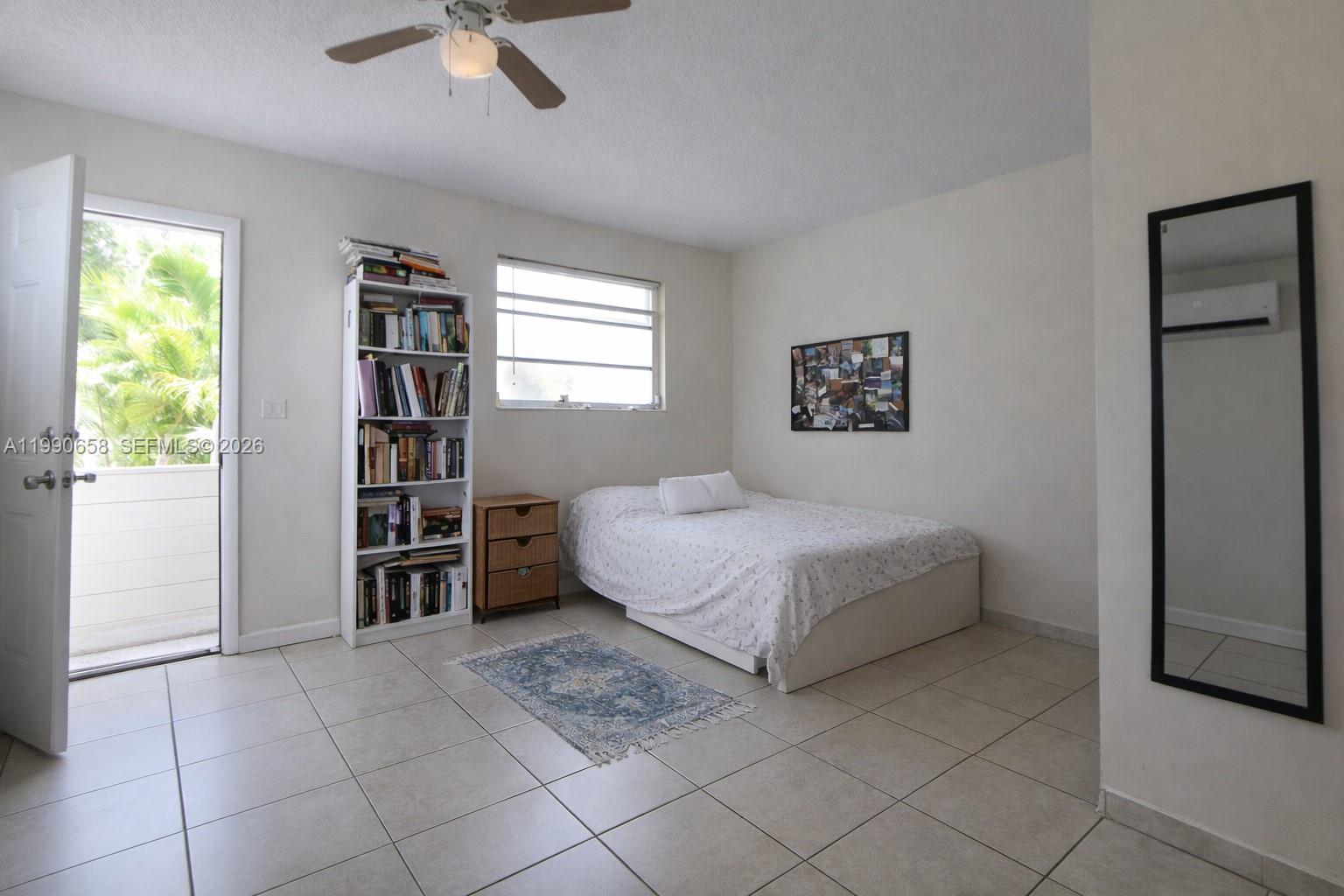 2314 Southwest 60th Avenue Miami, FL 33155 - Photo 26 of 45 a bedroom with a bed and a book shelf