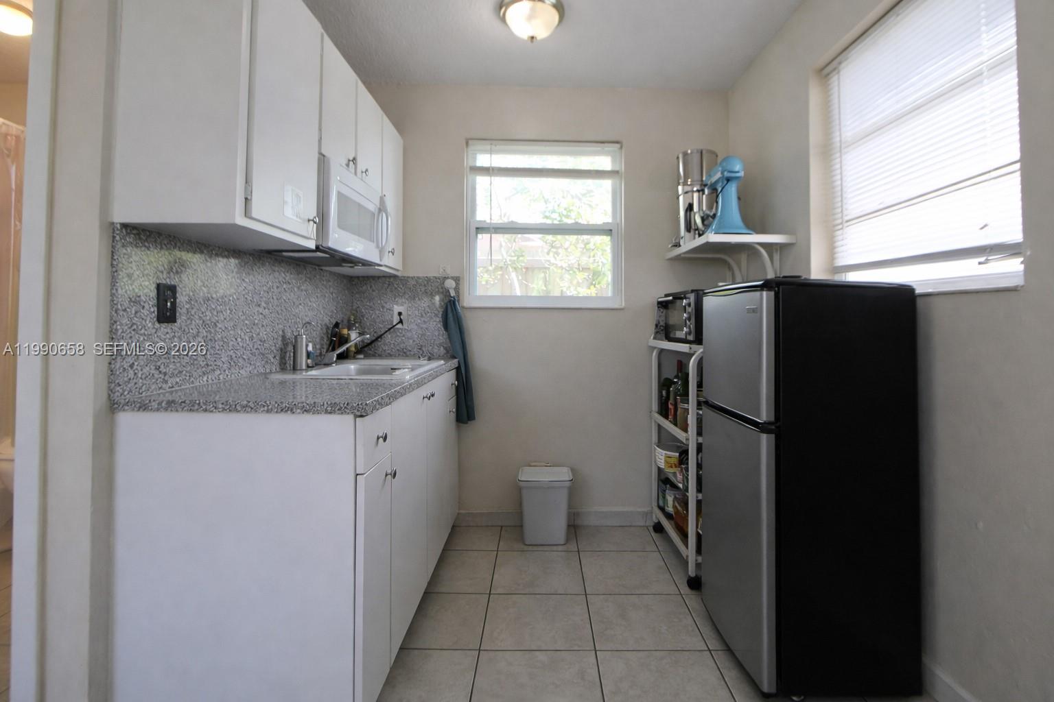 2314 Southwest 60th Avenue Miami, FL 33155 - Photo 27 of 45 a kitchen with a refrigerator and window