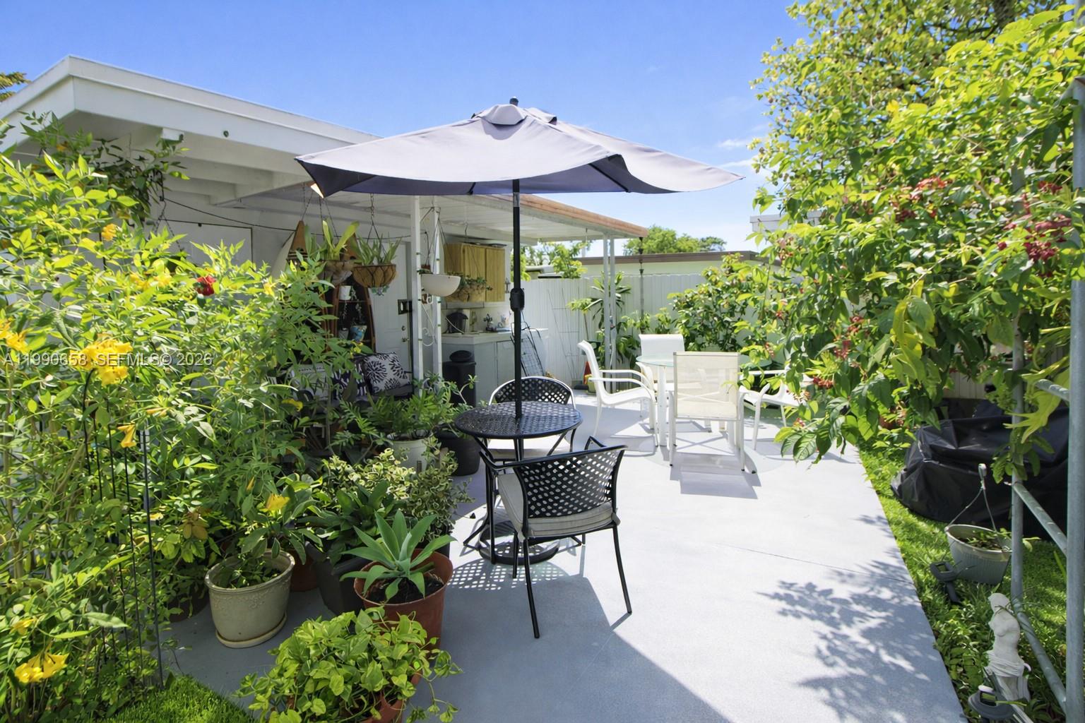 2314 Southwest 60th Avenue Miami, FL 33155 - Photo 29 of 45 a view of a patio with table and chairs potted plants