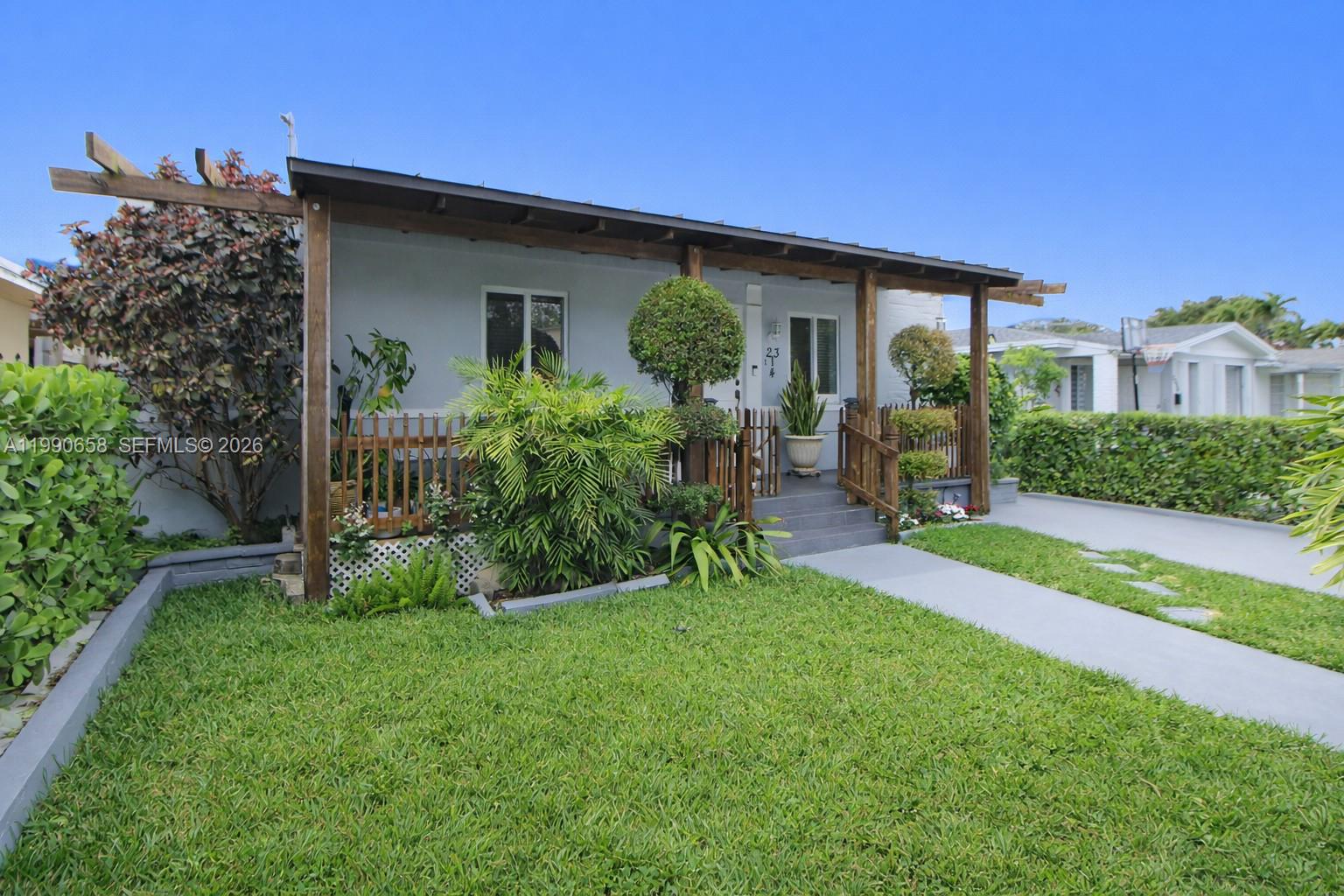 2314 Southwest 60th Avenue Miami, FL 33155 - Photo 3 of 45 a front view of a house with a yard