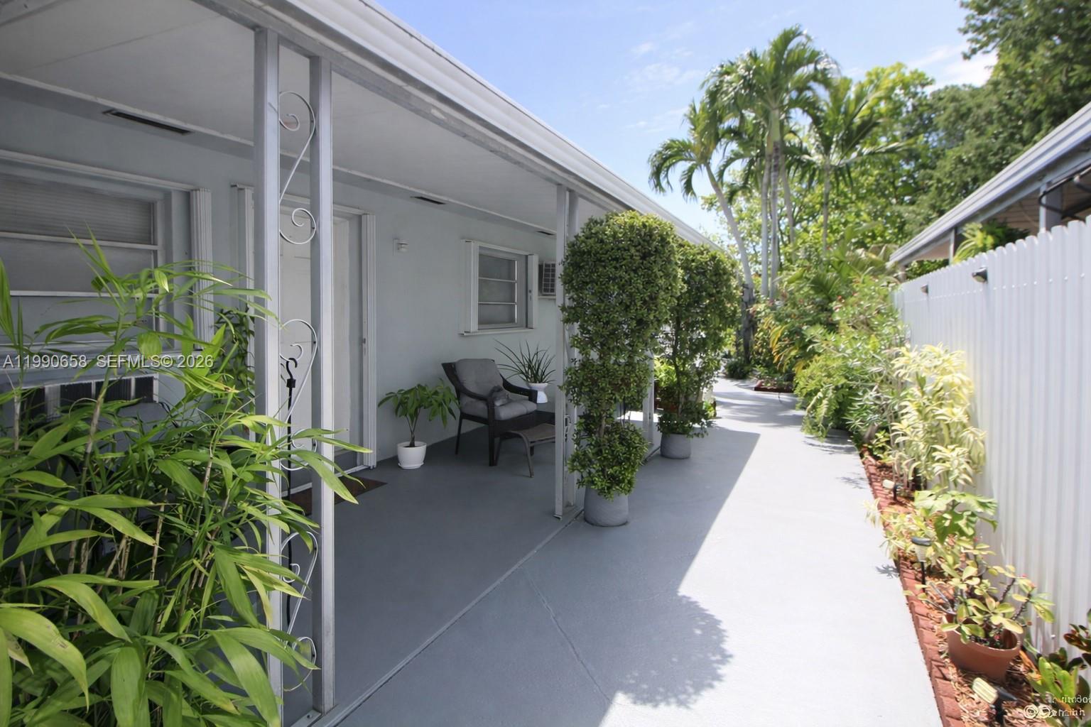 2314 Southwest 60th Avenue Miami, FL 33155 - Photo 31 of 45 a view of a backyard with chair potted plants