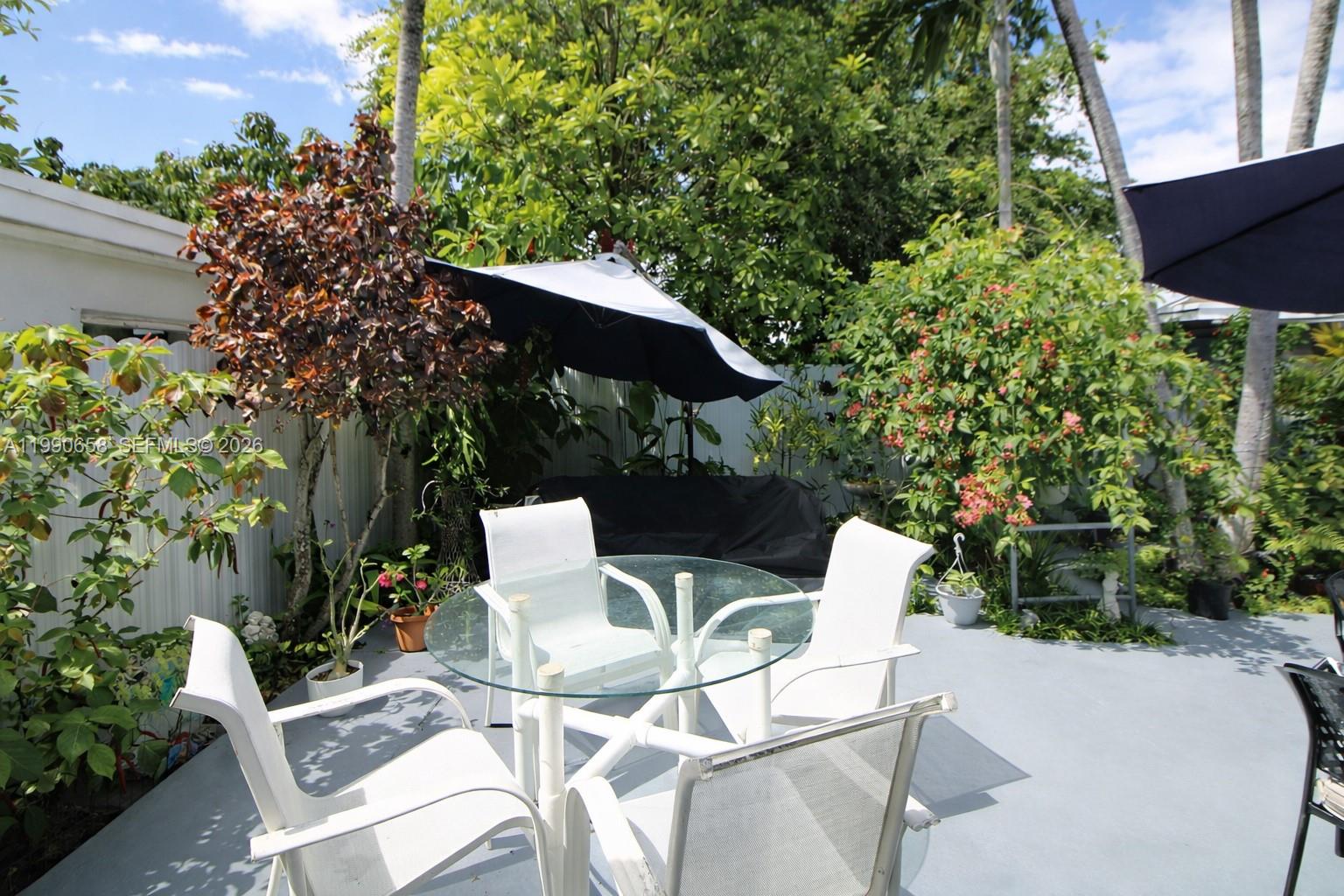 2314 Southwest 60th Avenue Miami, FL 33155 - Photo 34 of 45 a view of an chairs and table in the backyard