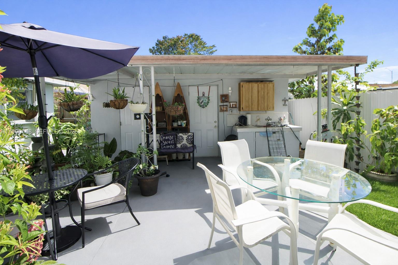 2314 Southwest 60th Avenue Miami, FL 33155 - Photo 35 of 45 a view of a patio with couches chairs and potted plants