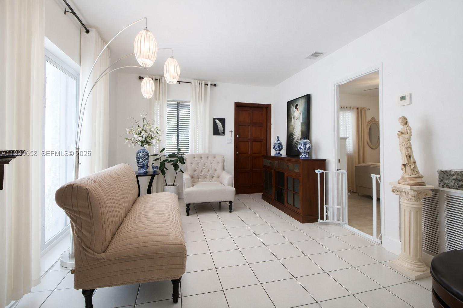 2314 Southwest 60th Avenue Miami, FL 33155 - Photo 7 of 45 a living room with furniture and a large mirror