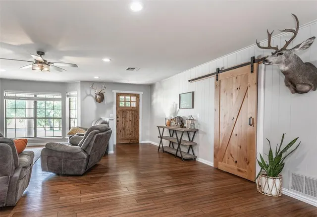 a living room with furniture and wooden floor