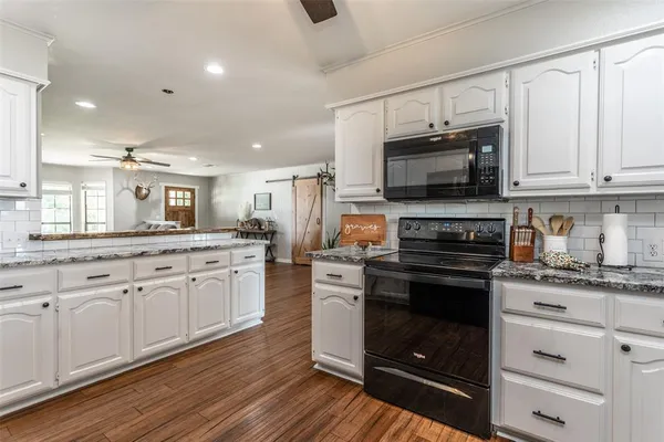 a kitchen with a sink stove and microwave