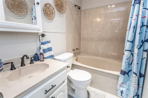 a bathroom with a sink a toilet and a bathtub