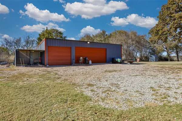a view of wooden house with a yard