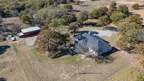 an aerial view of a house with a yard