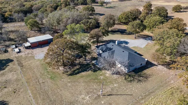an aerial view of a house with a yard