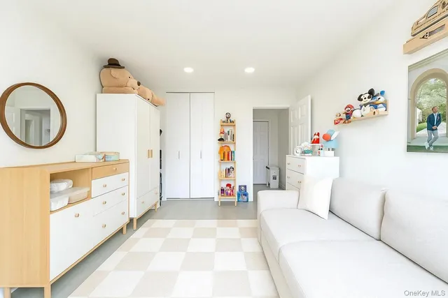 a living room with furniture and a large mirror