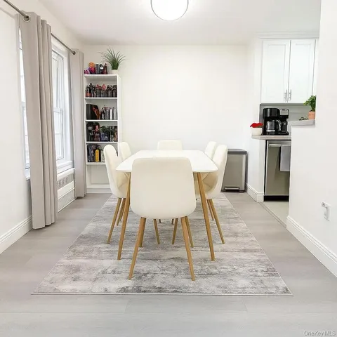 a dining room with a table chairs and a refrigerator