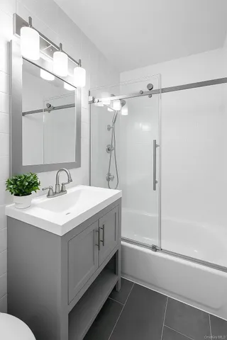 a bathroom with a sink a mirror and a shower