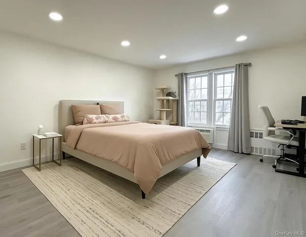 a bedroom with a bed a table and a couch