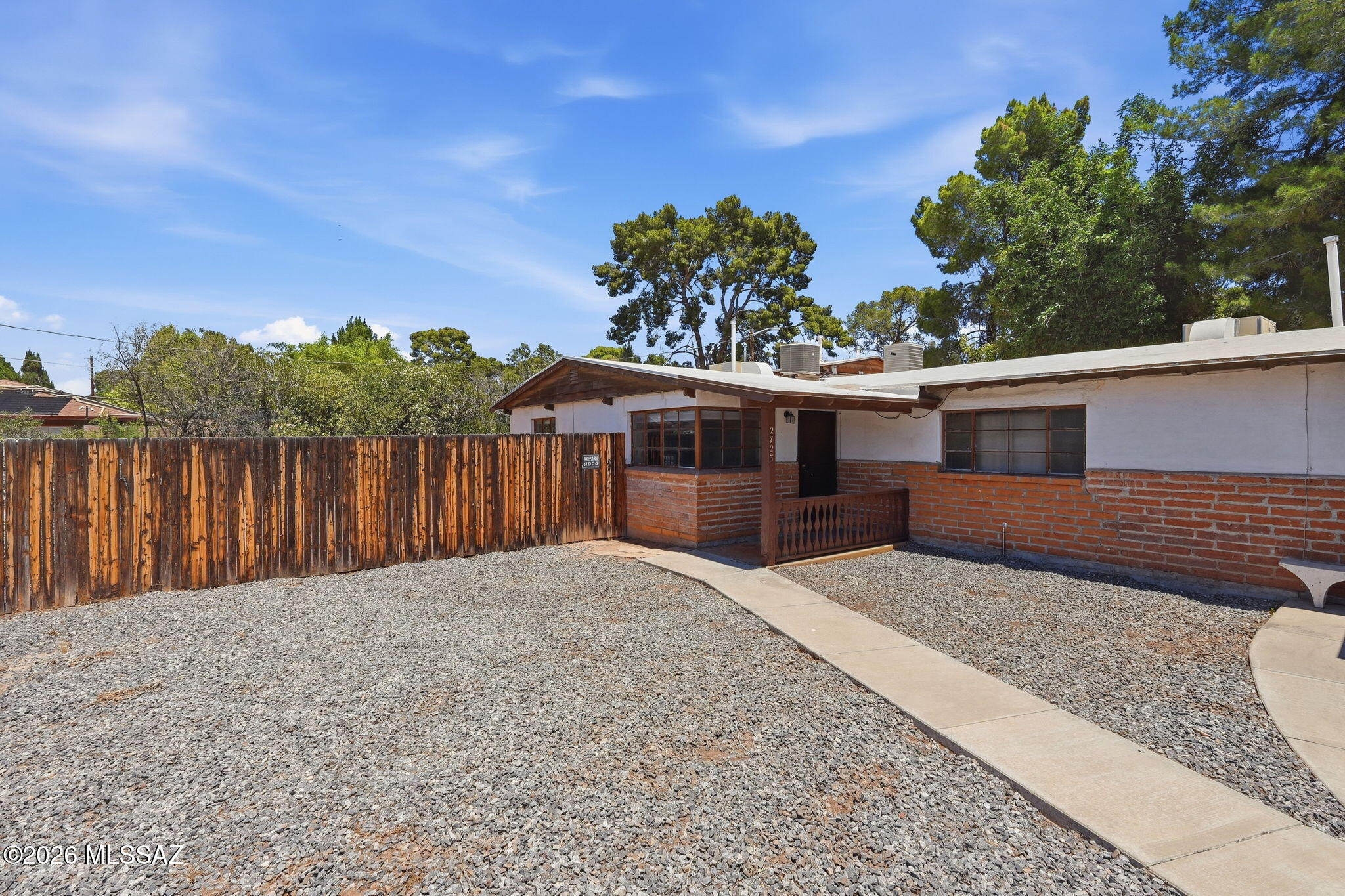 2721 East Fort Lowell Road Tucson, AZ 85716 - Photo 22 of 28 a front view of a house with a yard and mountain view
