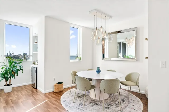 a dining room with furniture and wooden floor